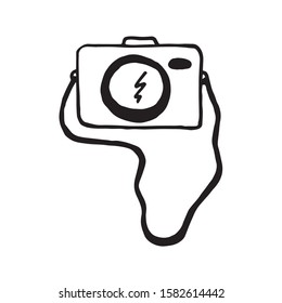 Vector illustration. Black photo camera on the strap isolated on white. Hand drawn simple doodle clipart.