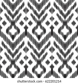 Vector illustration of the black and white colored ikat ornamental seamless pattern. Scribble textured effect. Fashion design in ethnic style.