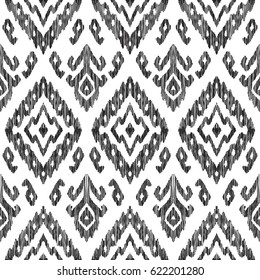 Vector illustration of the black and white colored ikat ornamental seamless pattern. Scribble texture. Design in modern ethic style.