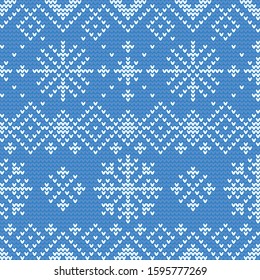 Vector illustration of a blue and white repeating, tileable, seamless snowflake-themed winter sweater pattern. Pattern can be tiled in any direction to make a larger pattern of any desired size.