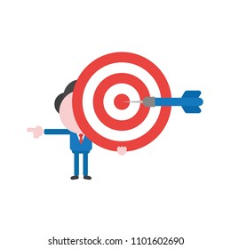 Vector illustration businessman character holding bulls eye with dart in the center and pointing.