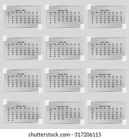 Vector illustration calendar of 2016 sheets of paper. Each month, an adhesive tape adhered to the paper background. Week starts on Monday.