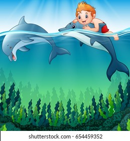 Vector illustration of Cartoon boy with dolphins in the sea