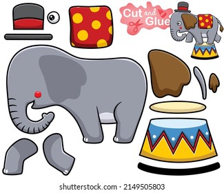 Vector illustration of cartoon elephant wearing magician hat on stage. Cutout and gluing