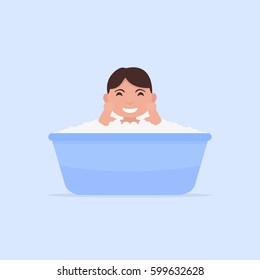Vector illustration of a cartoon little baby bathes in a small bath. Flat design. Child boy in foam and blisters is sitting in the bathroom.