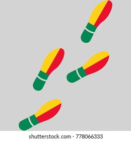 Vector illustration of chain of trails of shoes isolated on grey background, painted in the colors of national flag of Benin