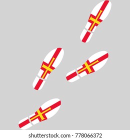 Vector illustration of chain of trails of shoes isolated on grey background, painted in the colors of national flag of Guernsey