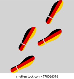 Vector illustration of chain of trails of shoes isolated on grey background, painted in the colors of national flag of Germany