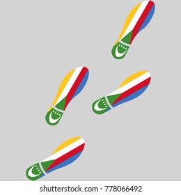 Vector illustration of chain of trails of shoes isolated on grey background, painted in the colors of national flag of Comoros