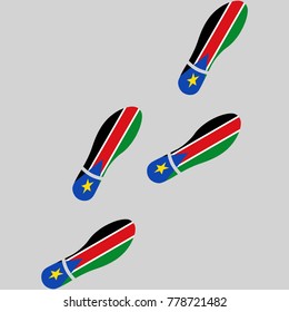 Vector illustration of chain of trails of shoes isolated on grey background, painted in the colors of national flag of South Sudan