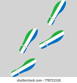 Vector illustration of chain of trails of shoes isolated on grey background, painted in the colors of national flag of Sierra Leone