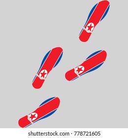 Vector illustration of chain of trails of shoes isolated on grey background, painted in the colors of national flag of North Korea