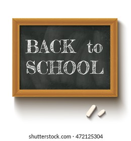Vector illustration of a chalkboard and chalks with text back to school