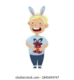 vector illustration of a child in a rabbit costume.  children celebrate christmas.  boy holding a box with a gift
