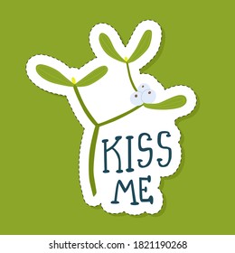 Vector illustration: Christmas sticker with a sprig of mistletoe. Kiss me lettering.
