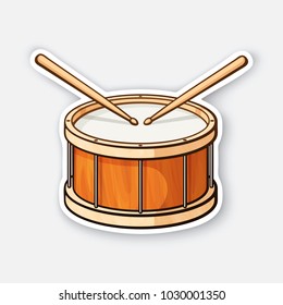 Vector illustration. Classic wooden drum with drumsticks. Percussion musical instrument. Rock or jazz equipment. Sticker with contour. Isolated on white background