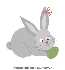 Vector illustration of cute bunny with colored egg isolated on white background. Easter traditional animal and design element. Cute spring icon picture