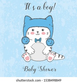 Vector illustration of cute hand drawn white kitten with winter fluffy blue hat, bow, cartoon card with handwritten lettering it's a boy, baby shower, drawing isolated on grunge scratched background