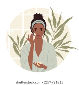 Vector illustration of a dark-skinned girl in a bathrobe applying cream on her face in the bathroom. Banner concept of cosmetology, beauty, home care, cosmetic procedures at home.