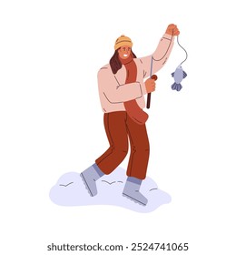 Vector illustration depicting a fisherman man in winter clothes holding a fishing rod and a caught fish. He is standing on snowy ice doing ice fishing. Flat illustration on isolated background.