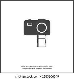 Vector illustration of a digital camera with film. Retro camera icon on white isolated background.  Layers grouped for easy editing illustration. For your design.