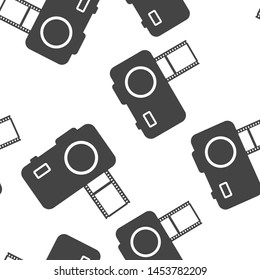 Vector illustration of a digital camera with film. Retro camera icon seamless pattern on a white background.