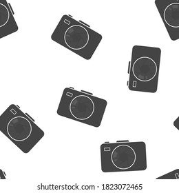 Vector illustration of a digital camera. Retro camera icon seamless pattern on a white background.
