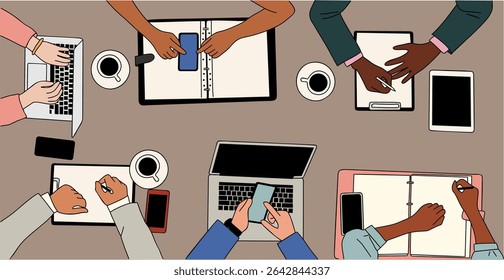 Vector illustration of diverse team working at a table with laptops, notebooks, smartphones, coffee, and tablets. Top view of modern office collaboration, brainstorming, and teamwork scene.