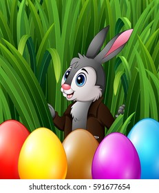Vector illustration of Easter bunny and colorful eggs in the grass bushes