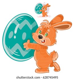Vector illustration of an easter bunny holding a decorated egg in its paws. Print