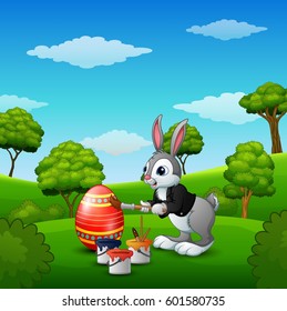 Vector illustration of Easter bunny painting easter eggs in the park