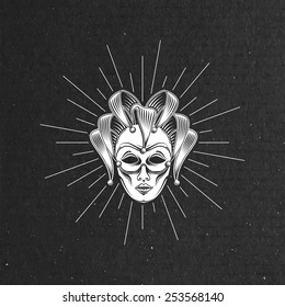 vector illustration of engraving venetian carnival mask or jester emblem and light rays on black cardboard texture. carnival symbol