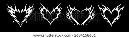 Vector illustration features four stylized white tribal flame heart designs on a black background. The edgy tattoo-inspired style combines love and fire motifs using bold, dynamic shapes and contrast.