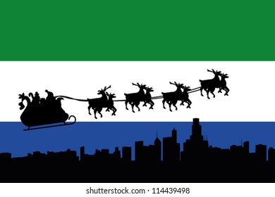 Vector Illustration of the flag of Sierra Leone with santa flying his sliegh over a city