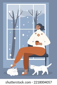 vector illustration in a flat style - a girl with a mug of tea sits by the window. it's snowing outside