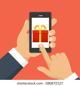 Vector illustration. Gift app page on smartphone screen. Hand hold smartphone. Mobile concept for web banners, web sites, infographics. 
