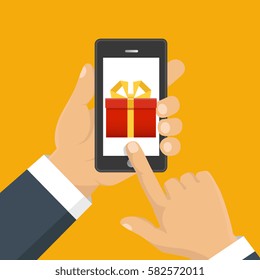Vector illustration. Gift app page on smartphone screen. Hand hold smartphone. Mobile concept for web banners, web sites, infographics. 

