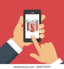 Vector illustration. Gift app page on smartphone screen. Hand hold smartphone. Mobile concept for web banners, web sites, infographics. 
