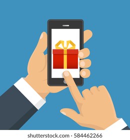 Vector illustration. Gift app page on smartphone screen. Hand hold smartphone. Mobile concept for web banners, web sites, infographics. 

