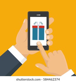 Vector illustration. Gift app page on smartphone screen. Hand hold smartphone. Mobile concept for web banners, web sites, infographics. 
