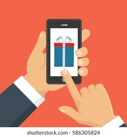 Vector illustration. Gift app page on smartphone screen. Hand hold smartphone. Mobile concept for web banners, web sites, infographics. 
