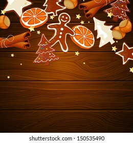 Vector illustration of gingerbread cookies and spices over wooden background