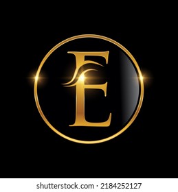 A Vector Illustration Of Golden Cursive Luxury Monogram Logo Initial Letter E In Black Background With Gold Shine Effect