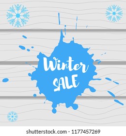 Vector illustration. Gray wooden background with color splash and inscription winter sale
