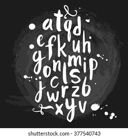 Vector illustration with hand drawn alphabet. Letters written with a brush on black background. The letters in the calligraphic style.