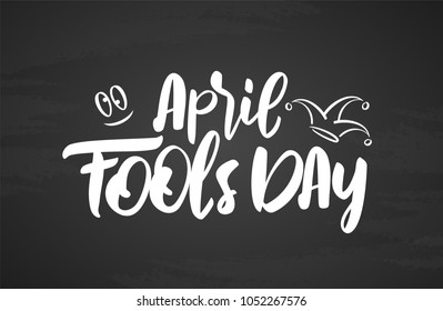 Vector illustration: Hand drawn brush type lettering of April Fools Day on blackboard background. 