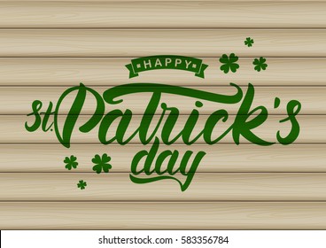 Vector illustration: Hand drawn brush lettering of Happy St. Patrick's Day on wood background. Typography design. 