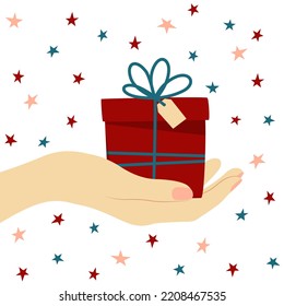 Vector illustration of a hand holding a gift box in a flat style on a white background with stars. Ideal for greeting cards, banners, wrapping paper, fabric printing.