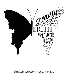 Vector illustration - hand lettering in butterfly silhouette. Beauty is the light in your heart - for cards, prints, t-shirts and posters. Calligraphic hand-lettering design