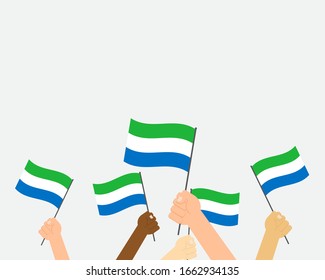 Vektorillustration der Hände, die die Flagge Sierra Leones auf weißem Hintergrund halten
